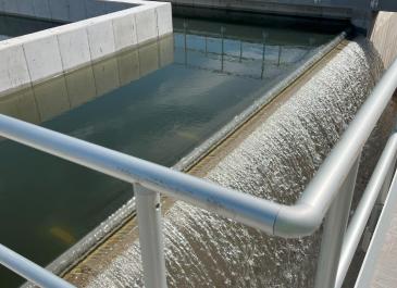 Treated effluent exiting over the discharge weir in the new chlorine contact tank