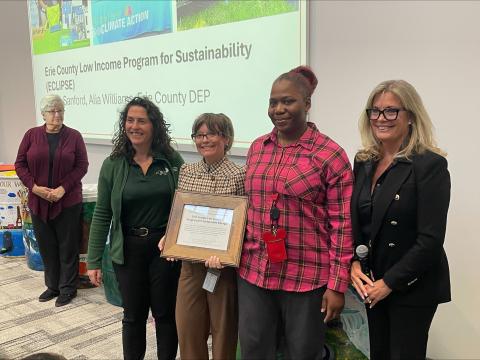 NYSDEC Commissioner Amanda Lefton (far left) and Deputy County Executive Lisa Chimera (far right) present the Environmental Excellence Award to ECLIPSE Coordinator Sarah Sanford (center left) and ECLIPSE Administrative Assistant Alia Williams (center right).