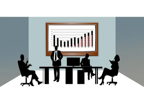 figures sitting around a meeting table