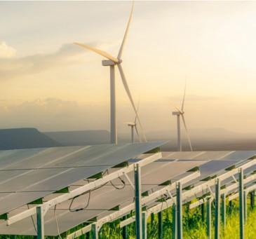 Solar panels and windmills in a grassy field. 