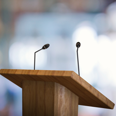 A speaker's podium with two microphones