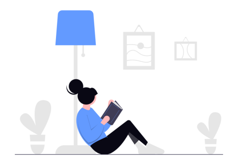 person relaxing against a lamp, reading a book