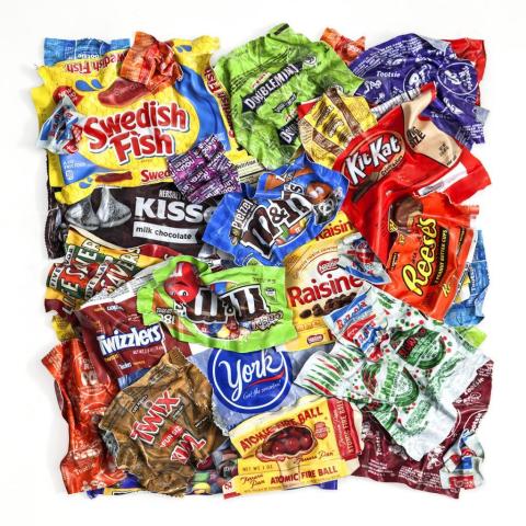 A square shaped collage made from many used candy wrappers