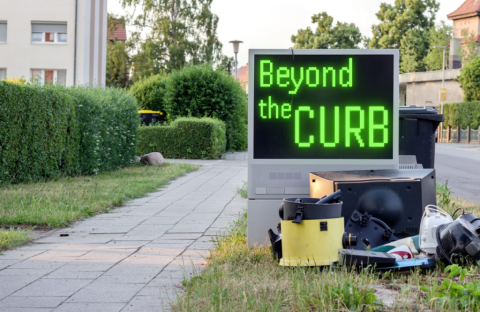 An image of various large items sitting at the curb waiting for collection. There is a large used TV among the items with the text "Beyond the Curb" displayed on screen.