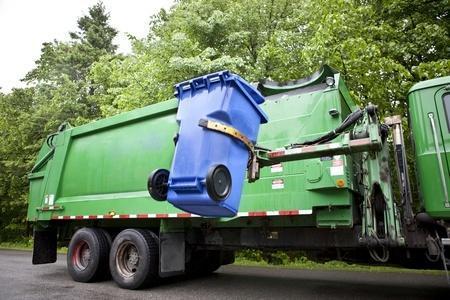 An image of a recycling truck lifting a curbside recycling bin.