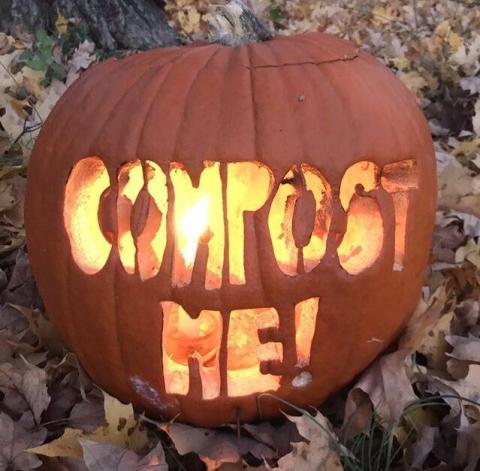 A jack o lantern with the phrase "Compost Me!" carved into it