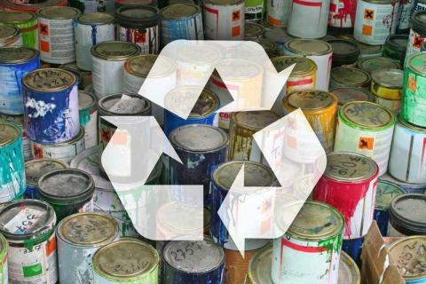 An image of used paint cans with a superimposed image of a recycling symbol