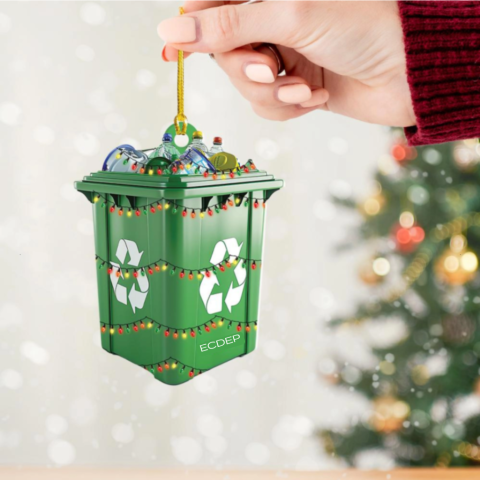 A christmas ornament that looks like a recycling bin